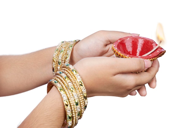 Woman hand holding Diya oil lamps for the Diwali festival