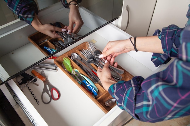 Woman hand holding fork in kitchen