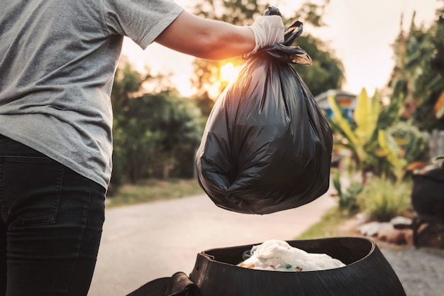 Woman hand holding garbage bag for recycle cleaning