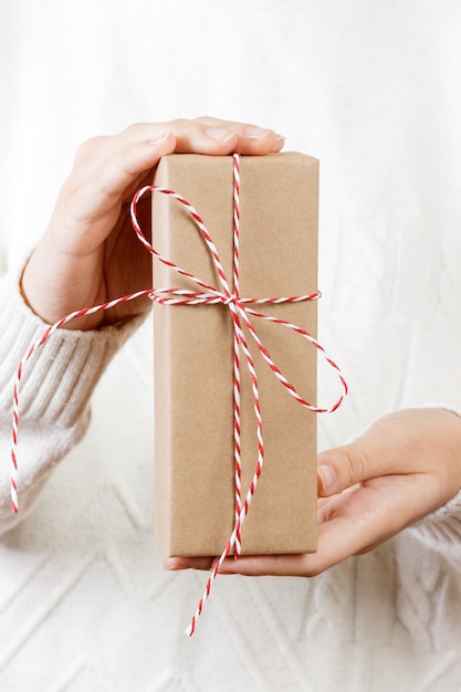 Woman hand holding gift box for Christmas