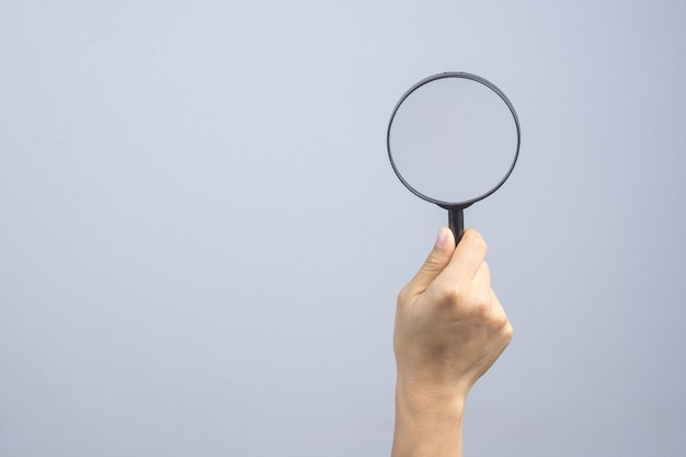 Woman hand holding magnifier