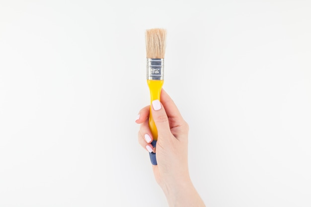 Photo woman hand holding new paint brush isolated