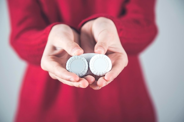 Woman hand holding optic lenses