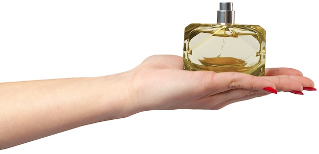 Woman hand holding perfume bottle,