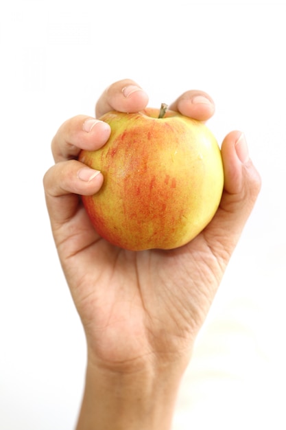 Woman hand holding red apple.