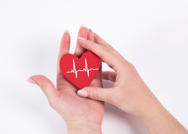 Woman hand holding red heart , heartbeat. Health concept