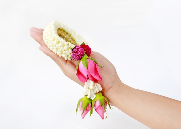 Woman hand holding thai garland for respect isolated on white background.