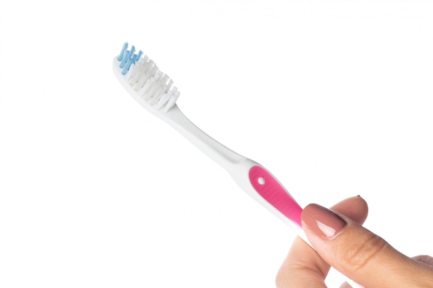 Woman hand holding a toothbrush isolated on white