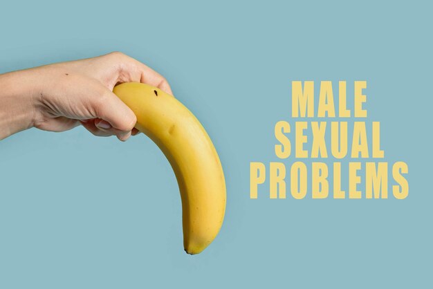 Woman hand holds banana tilted down symbol of erectile\
dysfunction male impotence or male sexual problems