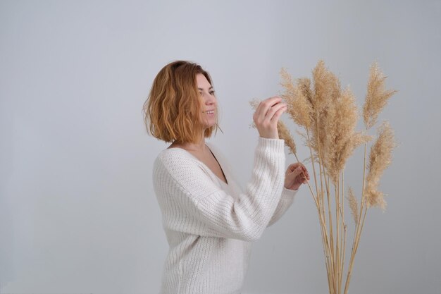 Woman hand holds the pampas grass reed plume stem dried pampas grass new trendy home decor