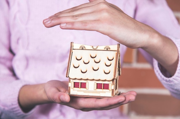 Woman hand house model