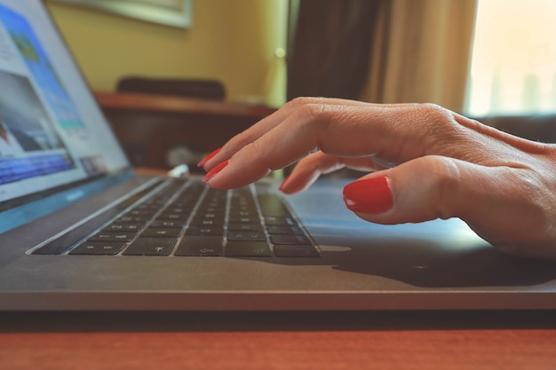 Woman hand on laptop