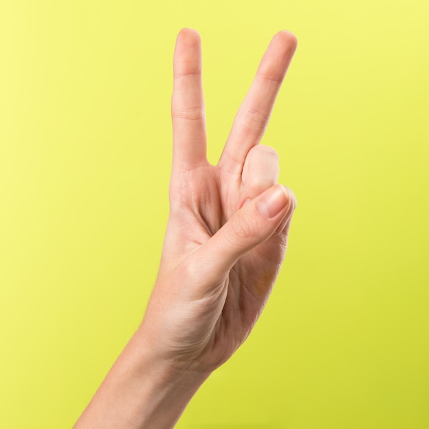 Woman hand making victory gesture