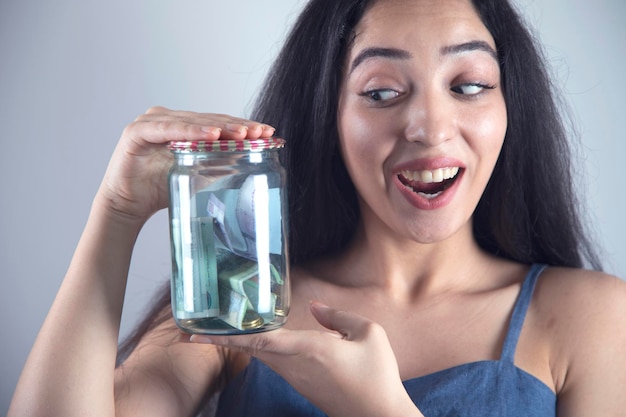 Woman hand money in jar