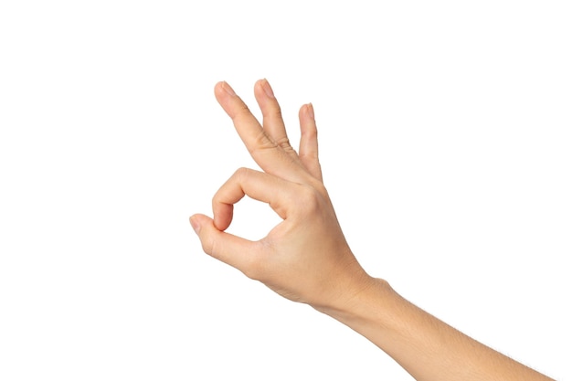 Woman hand ok sign on a white isolated background with clipping path