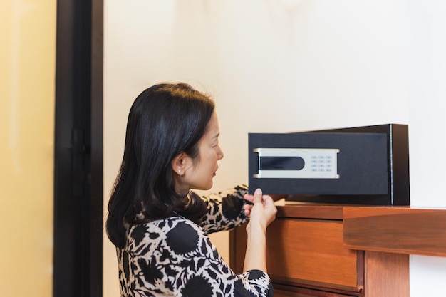 Woman hand opened a safe in hotel