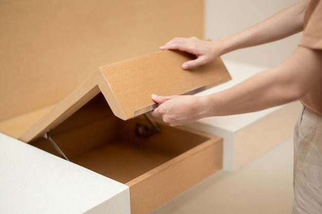 Premium Photo  Woman hand pull open drawer wooden cabinet.