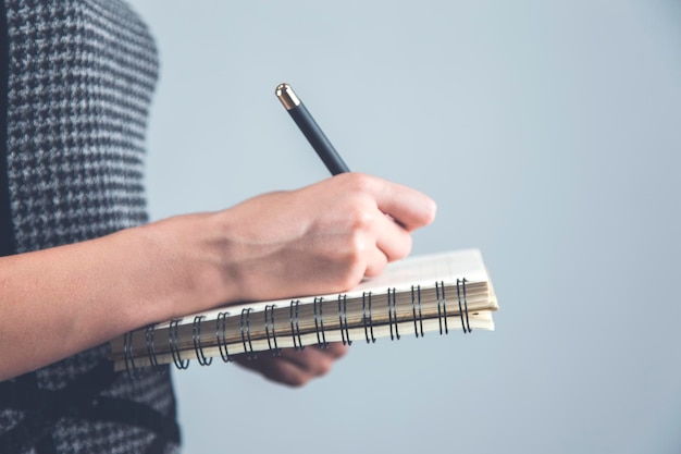 Woman hand pen and notepad