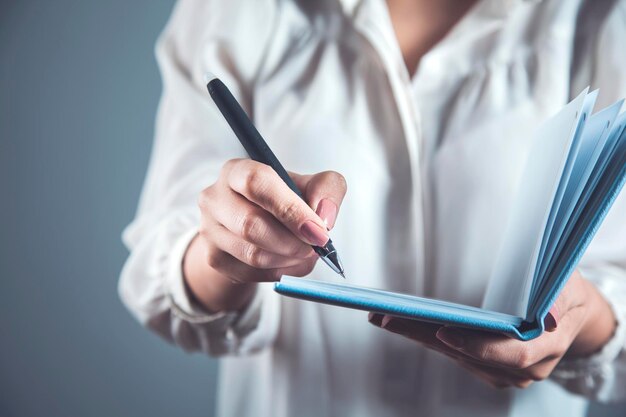 Woman hand pen and notepad