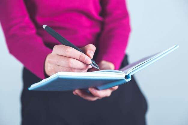 Woman hand pen with notepad