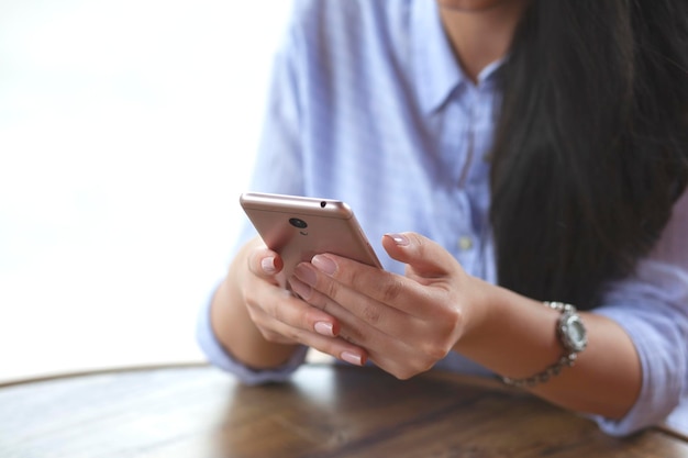 Woman hand phone and coffee