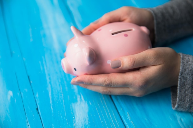 Woman hand piggy bank