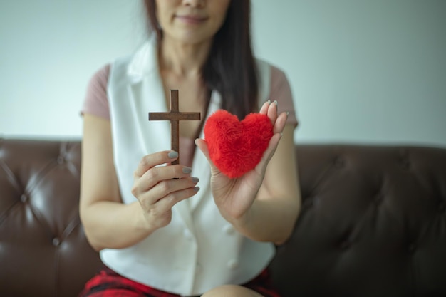 Woman hand pray with cross Concept of hope faith christianity