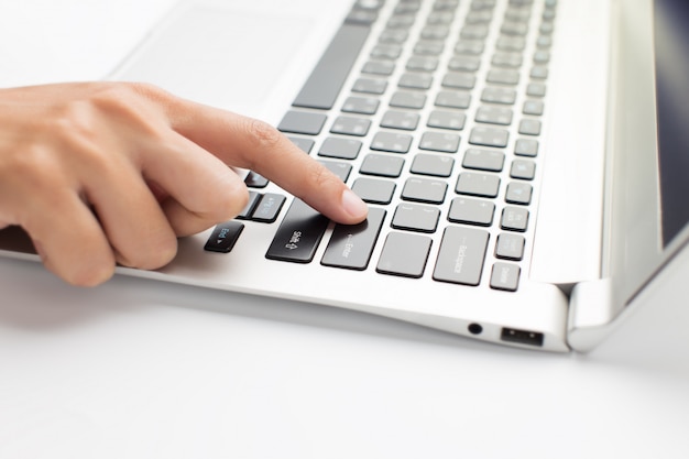 Woman hand press on laptop, close up