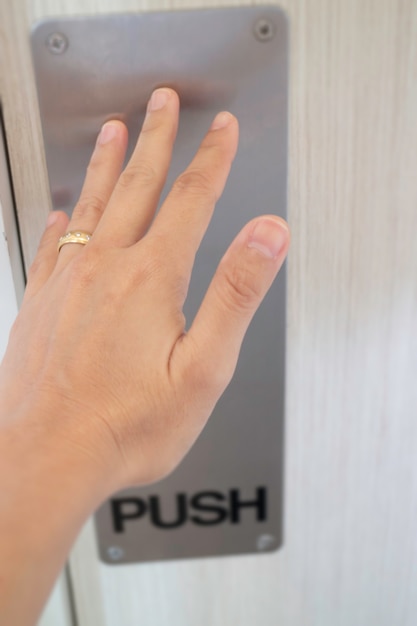 Woman hand pushing the door