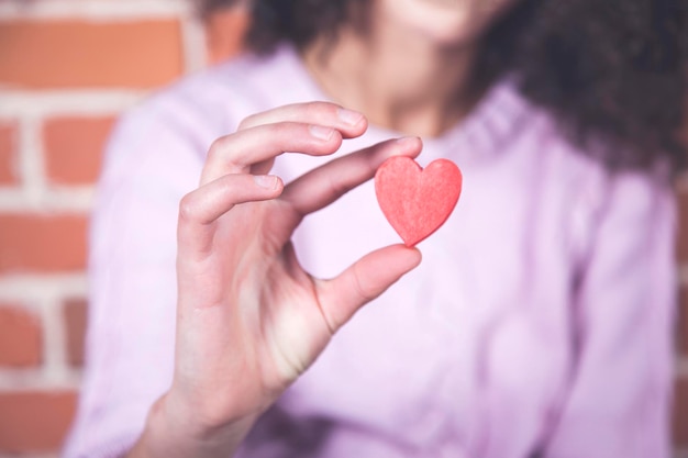 Woman hand red heart