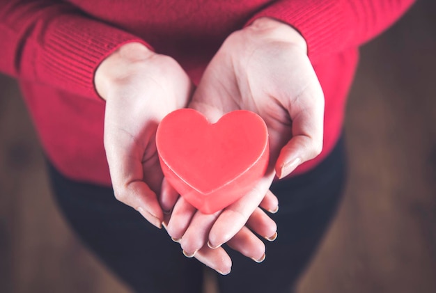 Woman hand red heart