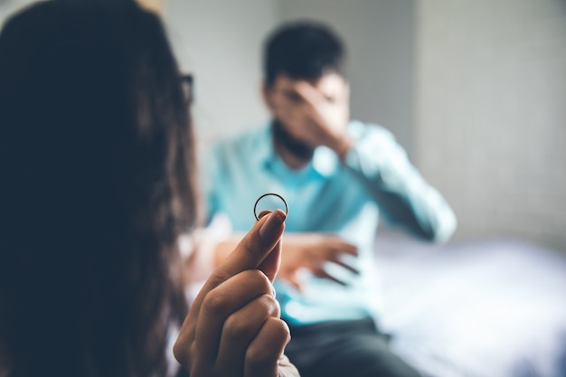 Woman hand ring with angry man in home