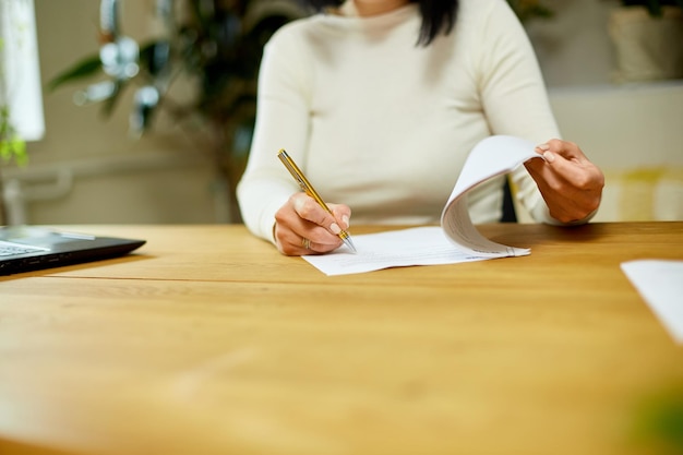 Woman hand signing a contract making a deal with business partner