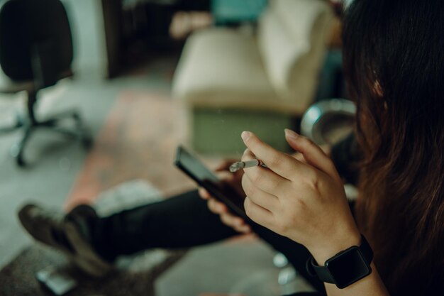 Woman hand smoking cigarette unhealthy lifestyle concept