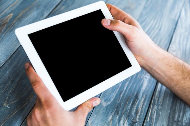 Woman hand touch white tablet with blank empty screen