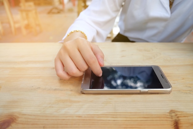 woman hand touching smartphone screen