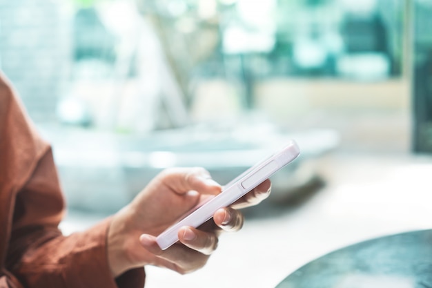 Woman hand use smartphone to do work and business or play social network.