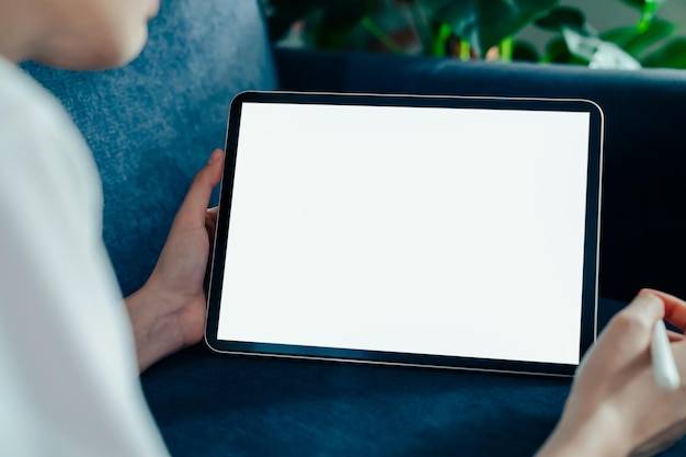 Woman hand using digital tablet and the screen is blank.