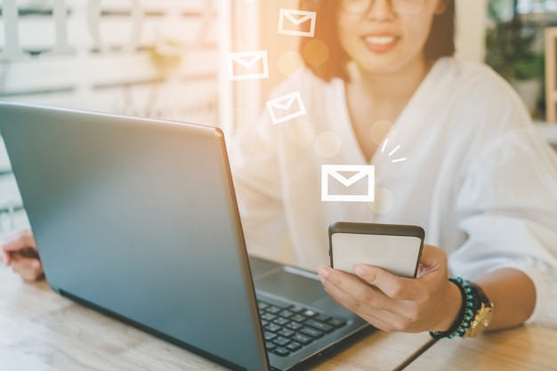 Woman hand using laptop computer to send and recieve email for business.