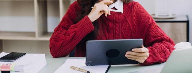 Woman hand using smart phone and laptop in outdoor nature park and sunset sky with bokeh light abstract background Technology business and freelance working concept Vintage tone filter color style