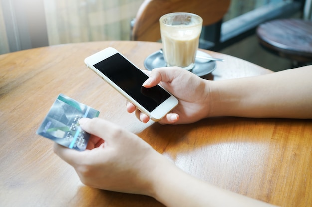 Woman hand using smartphone for mobile transaction or shopping online