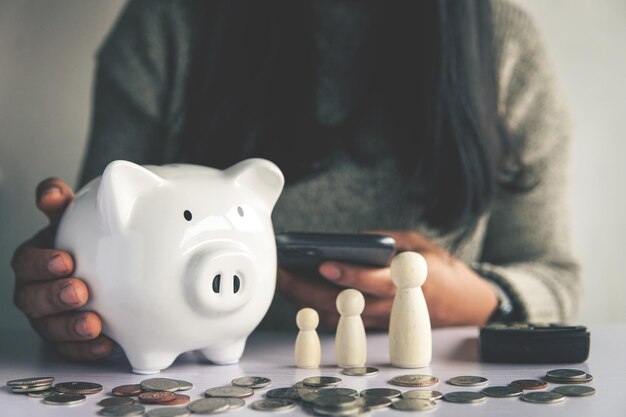 Woman hand and white piggy bank to saving money concept budget financial