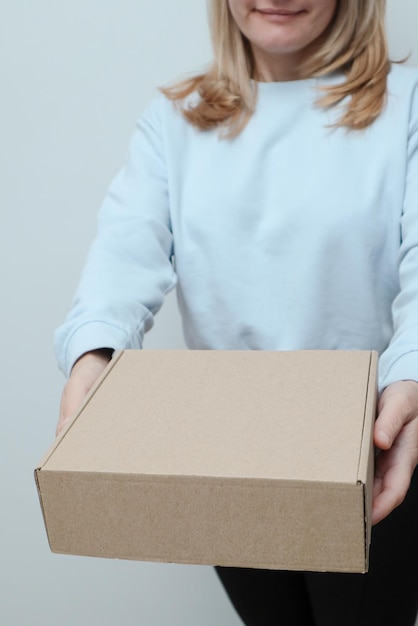 Woman hand with a delivery box on white background Delivery concept Delivery courier and shipping service concept