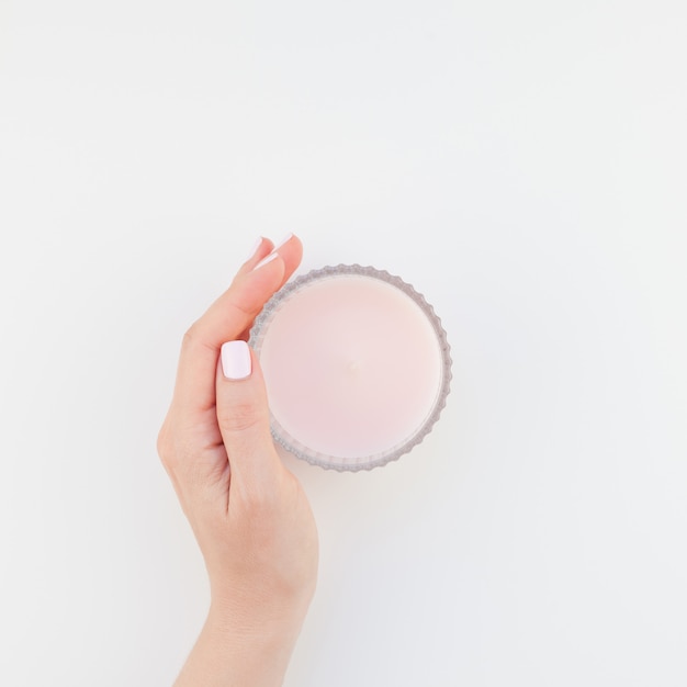 Woman hand with pink candle