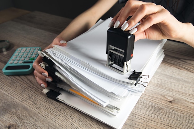 Woman hand with stamping documents