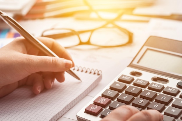 Woman hand working on calculator