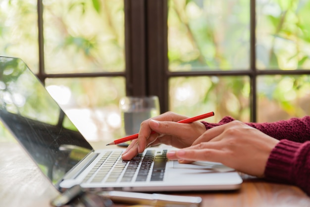 Woman hand working on her laptop. Social networking technology concept.