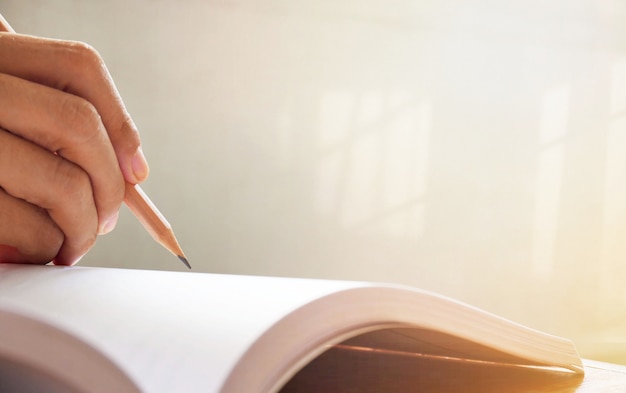 Woman hand writing on notebook