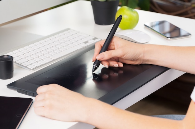 Woman hands graphic designer working on digital tablet