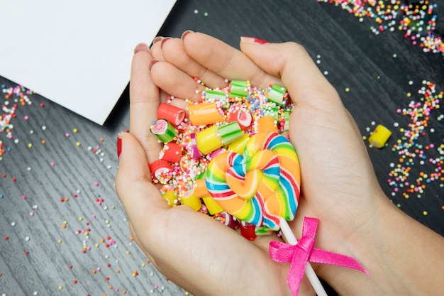 Woman hands holding assorted colorful candies